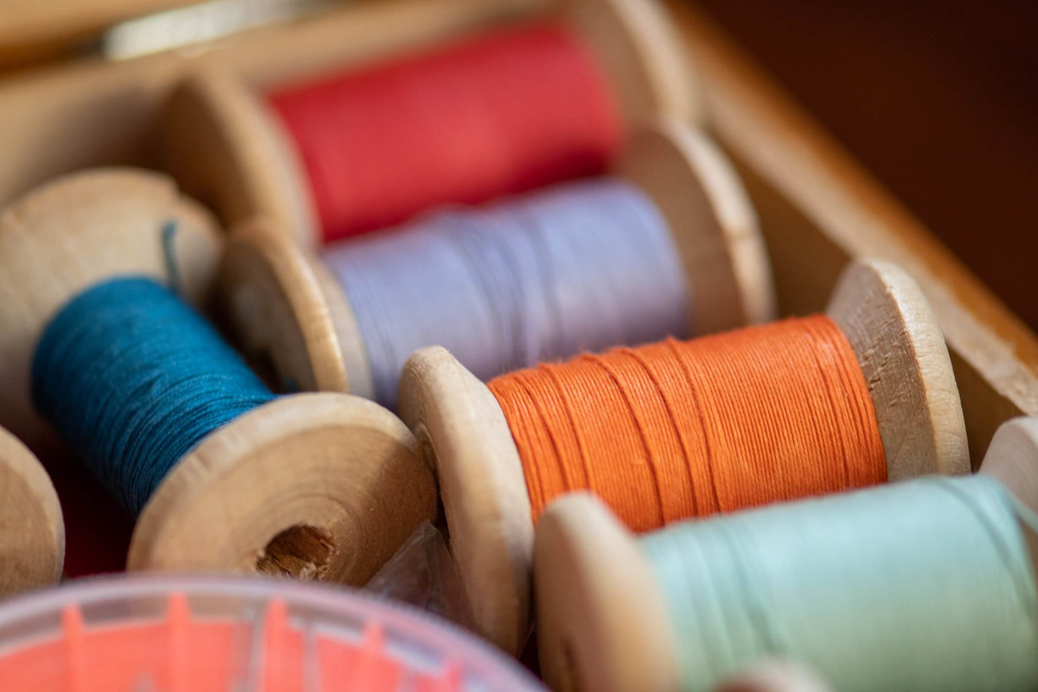 Heap of yarn spools symbolizing the intricacies of the textile industry, emphasizing EPR Textile and Textile Reporting.