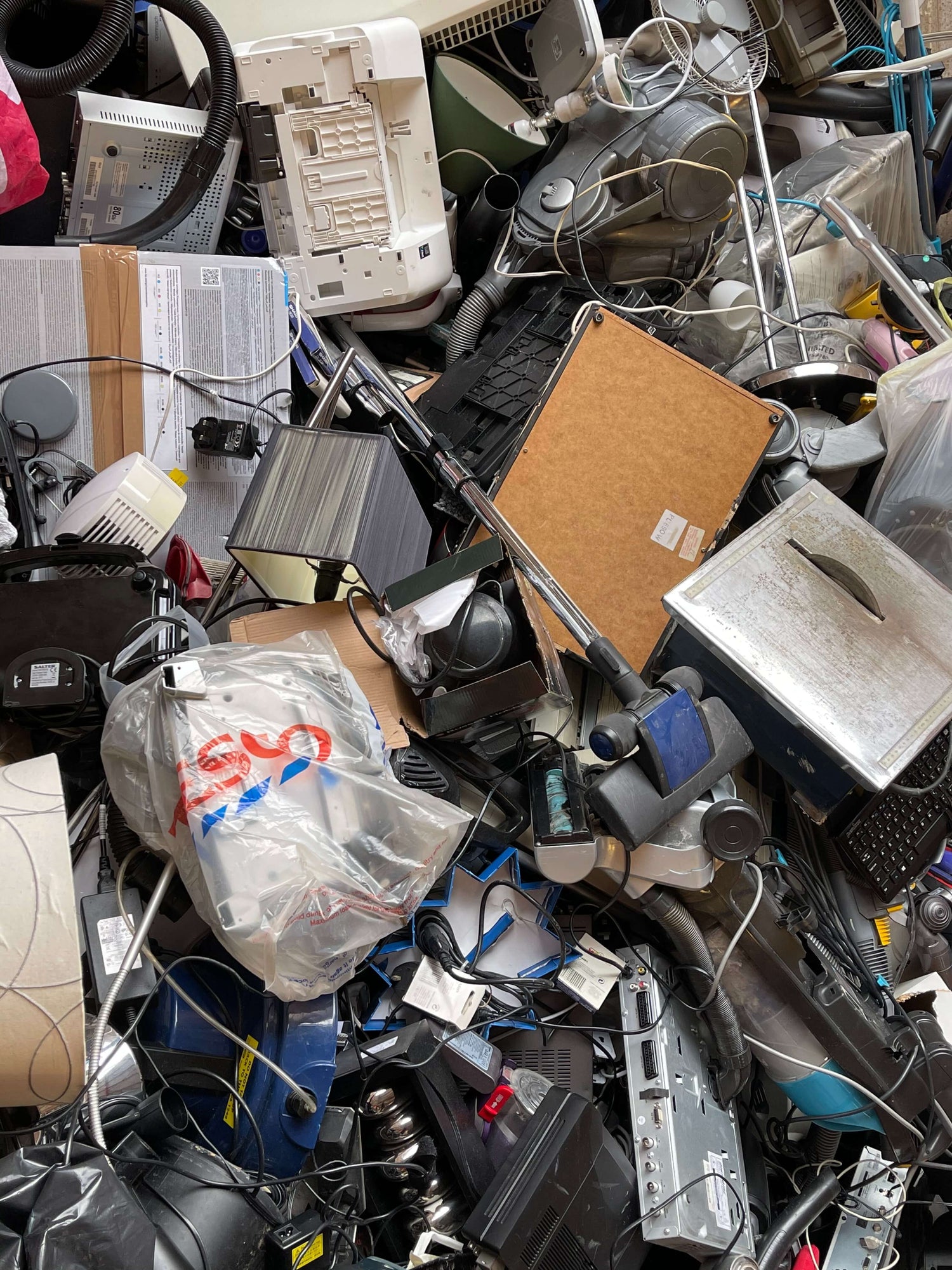 Large piles of discarded electronic devices, showcasing the magnitude of e-waste accumulation.